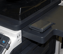 The proximity and HID iCLASS card authentication device (AU-201H/AU-202H) and CAC/PIV (AU-211P) connect directly to the USB port of Konica Minolta workgroup multifunction printers